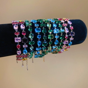 Detailed macro view of colorful zirconia bracelets with heart and teardrop stones in claw setting