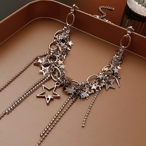Detail of silver star pendant necklace featuring sparkling rhinestones and hollow sequins