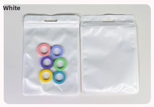 Macro view of colorful silicone rings in white translucent resealable packaging bag