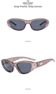 Detail of gray cat-eye sunglasses featuring wide temples and metallic star relief