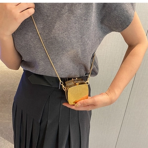 Mini metallic gold chain crossbody bag featuring high-shine mirror finish and square box design