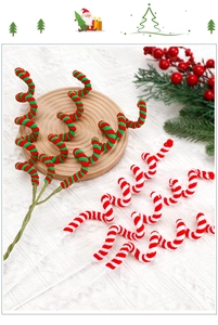 Macro detail of red and green fuzzy Christmas candy canes on a wooden tray with pine needles