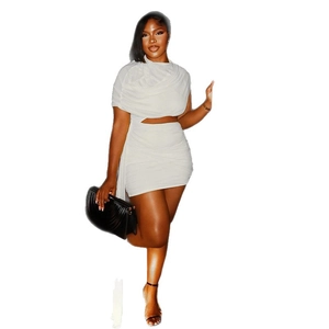 Sleeveless white pleated bodycon dress with lace-up detail and asymmetric hemline