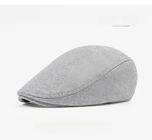 Detailed texture of light gray cotton beret newsboy cap with fine knitted fabric weave