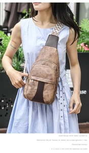 Brown vintage leather chest bag with a stylish black and white zigzag patterned strap