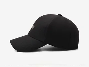 Detail of classic black baseball cap featuring fine gold embroidery on the side