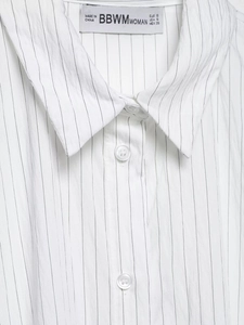 Close-up of a striped shirt neckline showing the fabric texture and brand label