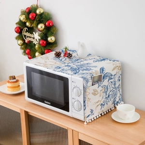 Detail of microwave dust cover featuring blue floral patterns and elegant bottom tassels