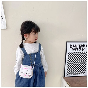 Girl wearing a white cartoon cat shoulder bag with pink ears and cute printed face