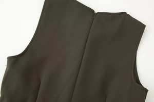 Detail of invisible back zipper and woven texture on olive sleeveless midi dress