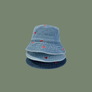 Three denim bucket hats in various blue washes featuring small red heart embroidery