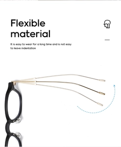Flexible metal hinges on black and gold glasses frame showing durability and material detail