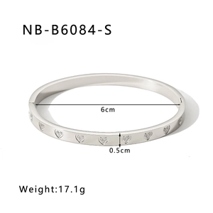 Detail view of silver heart pattern bangle with dimensions 6cm diameter and 0.5cm width