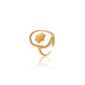 Detail of clear resin ring with internal 18K gold flower inlay and open band
