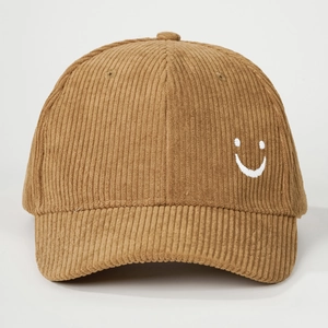 Detailed view of camel corduroy baseball cap with high-quality smiley face embroidery