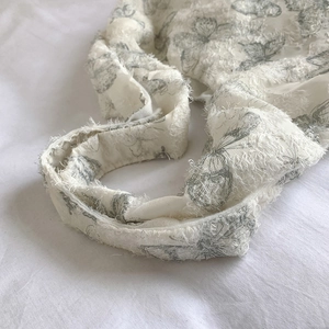 White minimalist tote bag with embroidered butterfly pattern and plush fuzzy texture