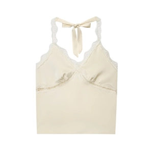 Detail of cream halter top featuring intricate lace trim and glossy satin fabric texture