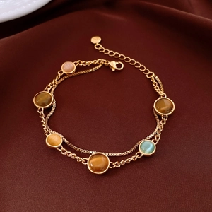 Detail of 18k gold plated double-layer bracelet with colorful opal beads on silk background