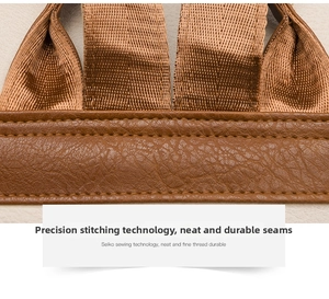 Close-up of vintage brown PU leather with reinforced stitching and textured ribbon detail