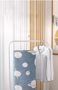 Detail of space-saving spiral laundry rack holding a large blue galaxy bed sheet