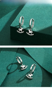 Detailed close-up of s925 silver rocking horse earrings with sparkling cubic zirconia inlay