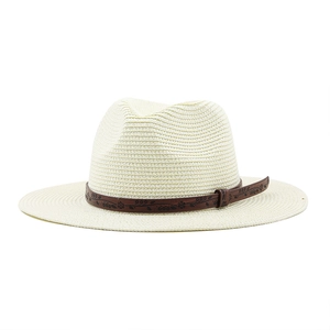 Detail of woven straw sun hat with vintage floral pattern dark brown decorative band