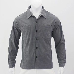 Macro shot of grey corduroy texture and buttoned chest pockets on men's shirt