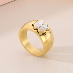 Detail of 11mm wide gold titanium ring with clover-shaped white shell inlay detail
