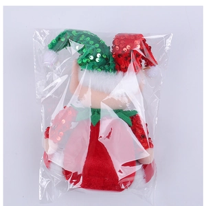 Close-up of plush Christmas gnome doll with sequins hat inside protective packaging