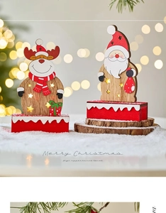 Detail of wooden Santa and reindeer LED ornaments with star cutout and snowy red base