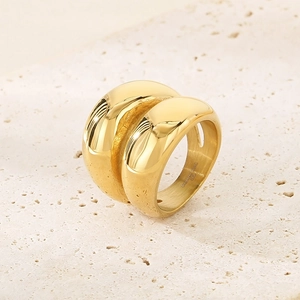 Macro detail showing 316L stainless steel engraving on high polished gold double band ring
