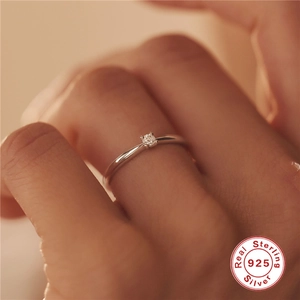 Macro detail of a 925 sterling silver ring with a sparkling round-cut solitaire diamond