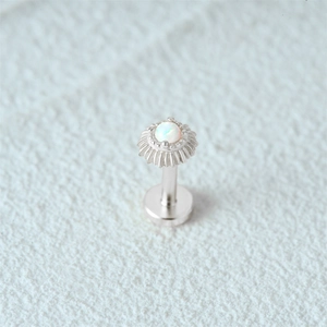 Macro view of S925 silver flat back stud earring with opal inlay and radial texture