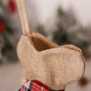 Plaid burlap bone-shaped Christmas stocking for pets hanging on a festive tree