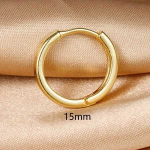 Macro shot of 15mm golden huggie hoop earring on champagne satin fabric detail