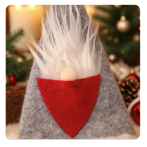 Close-up of a handmade Christmas gnome cutlery holder with grey felt hat and white beard