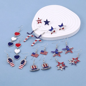 Detail of USA flag earrings featuring red, white, blue enamel and sparkling rhinestones