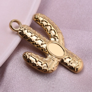Polished 18k gold plated stainless steel cactus pendant on soft pink silk background