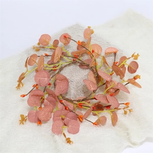 Autumn candle ring with dusty pink eucalyptus leaves and orange berries on white fur