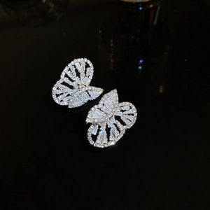 Detailed view of silver butterfly earrings with shimmering crystals and cubic zirconia