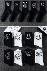 Detail of knitted cotton basketball socks with street style graffiti and monster patterns
