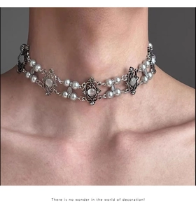 Detail of vintage silver choker featuring multi-layer pearls and oval gemstones