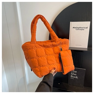Quilted puffer tote bag in orange with matching coin purse and stylish top handle detail