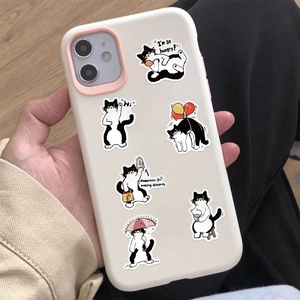 Close-up of waterproof cow cat stickers with cute expressions on a white phone case