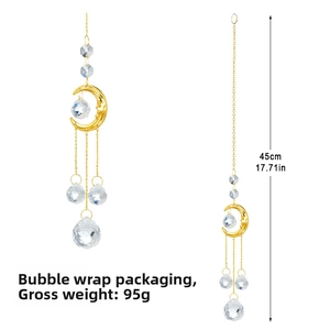 Detail of a 45cm suncatcher featuring a golden crescent moon face and faceted K9 crystals