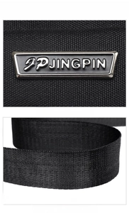 Detail of metal logo plate on waterproof black nylon bag with durable woven strap