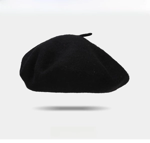 Close-up of black wool beret featuring red heart embroidery and comfortable texture
