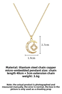 Macro detail of gold titanium crescent necklace with micro-pave clover pendant insert