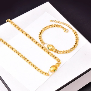 Hip hop style gold snake head necklace and bracelet set with green gemstone eyes