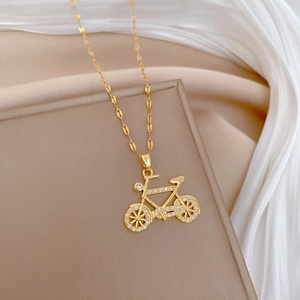 Macro shot of gold-plated bicycle necklace pendant with micro-inlaid sparkling zircon stones
